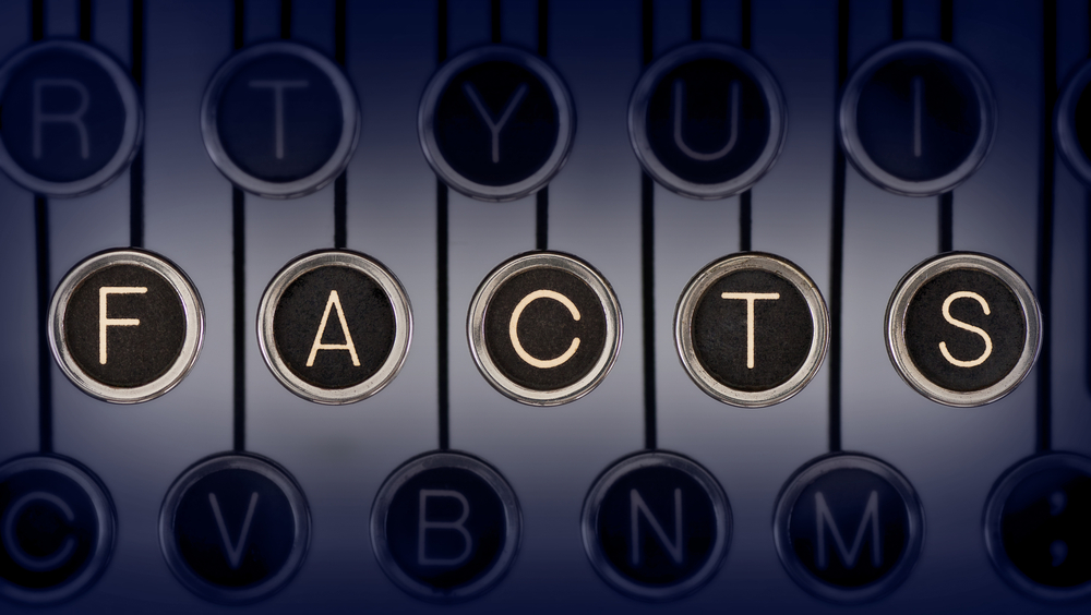 The word FACTS spelled out in old-fashioned round typewriter keys.