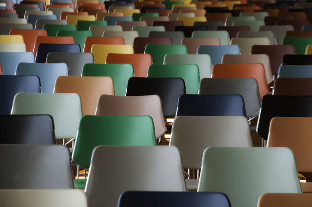 A colorful collection of chairs in a large conference hall.