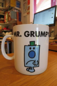 A mug with a drawing of the character Mr. Grumpy.