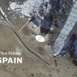 A screenshot of a video. It shows an aerial image of what appears to be a radiotelescope, it has the text "Pico Veleta SPAIN".
