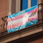 Transgender Pride flag hanging on balcony