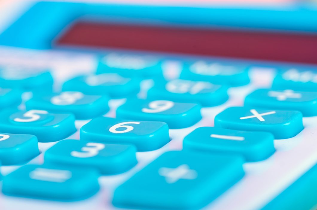 close-up and selective focus shot, calculator on wooden desk